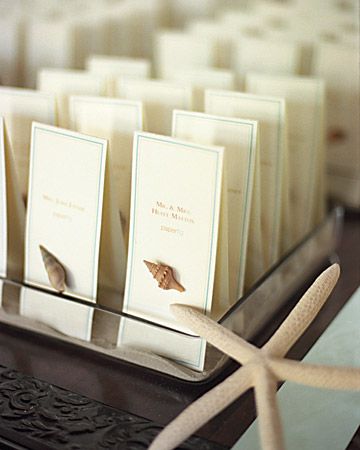 Beachy place cards embellished with tiny seashells