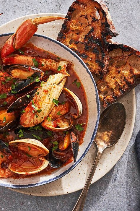 An abundance of seafood and three types of fennel (bulb, seed, and pollen) infuse Boudet's version of this San Francisco fish stew with remarkable flavor, while Calabrian chile paste and crushed red pepper add a subtle layer of heat.#seafood #seafoodrecipes #seafooddishes #recipes Italian Fish, Feast Of The Seven Fishes, Fennel Bulb, Seven Fishes, Cozy Cottages, Grilled Bread, Seafood Stew, Dungeness Crab, Fish Stew