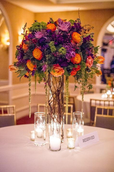 Purple and orange fall arrangement. Branching Out Floral & Event Design Photography: Amy Herfurth Photography - www.amyherfurth.com  Read More: http://www.stylemepretty.com/texas-weddings/2014/01/15/colorful-rosewood-turtlecreek-mansion-wedding/ Purple And Orange Wedding, Purple Wedding Centerpieces, Fall Purple, Tall Wedding Centerpieces, Fall Wedding Centerpieces, Wedding Table Flowers, Floral Event Design, Tall Vase, Fall Wedding Flowers