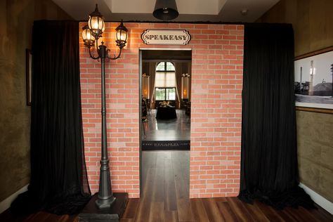 Custom made speakeasy secret entrance door for a Prohibition party theme with Roaring 20's Art Deco graphics and decor  by Unlimited Events  #gatsbyparty #greatgatsby #roaring20s #speakeasy #themeparty #speakeasydoor #customeventdecor #prohibition #prohibitionparty #roaring20stheme Prohibition Halloween Party, Speakeasy Secret Door, Prohibition Party Decorations Diy, Bootleggers 1920s Speakeasy Party, Roaring 20s Halloween Party, Speakeasy Door Entrance Diy, Roaring 20s Party Entrance, Speakeasy Photo Booth, Speakeasy Bar Entrance