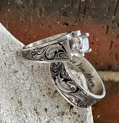 🪶 Birds of a feather flock together 🪶 📸 ℹ️ Material: Sterling Silver Engraving: Bright Cut w/ accent feathers Finish: Antiqued Center Stone 1 carat #jensensilver #customsilver #rodeofashion #engraved #westernfashion #westernwedding #rancher #cowboy #sterlingsilver #sterlingsilverring #scrollwork #brightcutengraving #westernweddingrings #ranchwife #ranchwedding #westernring #engravedengagementring #cubiczirconia #westernweddingmagazine #customdesign #cowboyfashion #handengraved #engrav... Western Wedding Rings Sets, Western Wedding Rings, Western Rings, Engraved Engagement Ring, Wedding Items, Rings Unique, Rodeo Fashion, Birds Of A Feather, Western Wedding