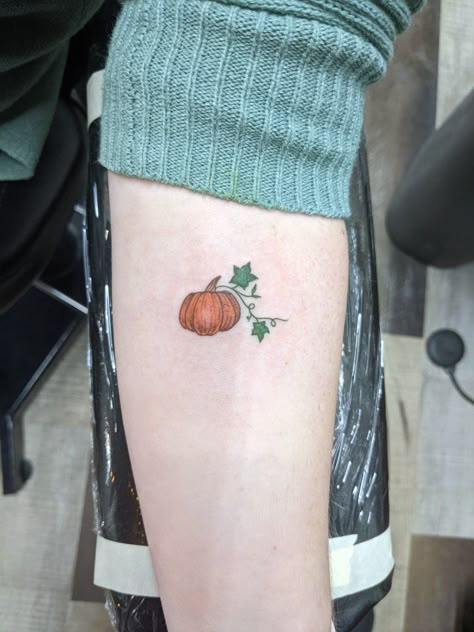 Tiny pumpkin tattoo with orange and green ink Pumpkin Leaf Tattoo, Minimalist Pumpkin Tattoo, Small Pumpkin Tatoos, Tiny Pumpkin Tattoo, Pumpkin Tattoos For Women, Pumpkin Vine Tattoo, Small Pumpkin Tattoo, Pumpkin Tattoo Ideas, Tattoos Horoscope