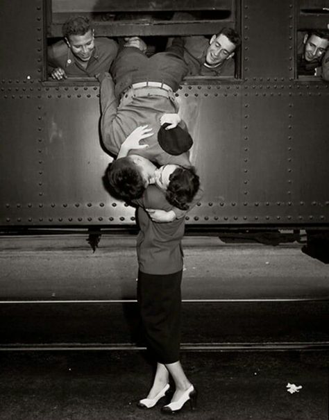 A soldier leans out of train window to kiss a woman goodbye in 1950. Two People, A Train, Kiss, Train, Black And White, White, Black