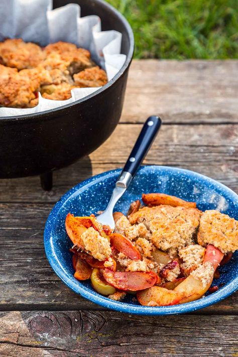 This Dutch Oven Apple Cobbler is such a fun camping dessert! Filled with cinnamon-spiced apples and topped with a buttery, sweet topping, this dutch oven cobbler is sure to be a family favorite. Dutch Oven Apple Cobbler, Cabin Meals, Dutch Oven Cobbler, Oven Desserts, Dutch Oven Desserts, Camping Dessert Recipes, Camping Cooking Equipment, Camp Meals, Dutch Oven Camping Recipes