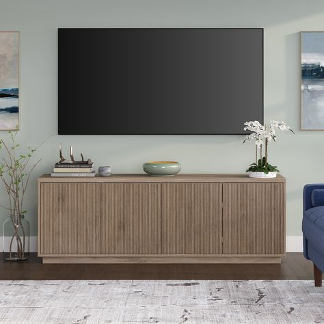 On-trend texture and design combine in this transitional TV stand. With a wood grain finish and textured doors, this piece is sure to be a statement in your living room, den, or game room. Tv Console Cabinet Living Room, 75” Tv Stand, Gray Tv Stand Living Room, Tv Stand For Small Living Room, Neutral Tv Stand, Walmart Tv Stand, Modern Entertainment Center Ideas, Scandinavian Tv Console, Tv Console Ideas Living Rooms