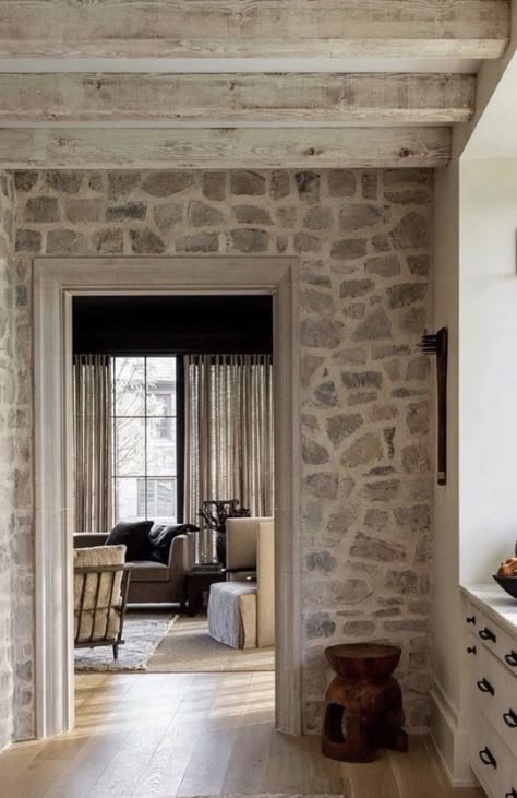 Exposed Stone Wall Interior, Barn Door On Rock Wall, Old Stone Wall Interior, Cottage Kitchen Stone Wall, Lakehouse Fireplace, Stone Wall In Kitchen French Country, Indoor Stone Wall, Stone Cottages Interior, Mountain House Interior