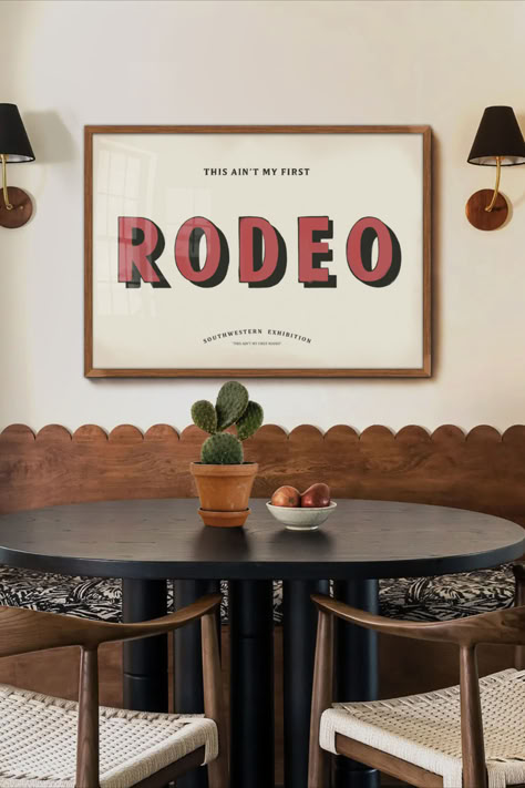 This typography print offers a retro twist on the renowned saying, "This Ain't my first rodeo." This delightful hand-painted style print is the ultimate wall decor for western, southwestern, or southern spaces. It serves as a striking statement piece in cabins, lodges, farmhouses, or ranch homes. Over The Bed Wall Decor Paintings & Prints, Organic Modern Western Decor, Minimalistic Western Decor, Rodeo House Decor, Retro Western Living Room, 70s Western Decor, Mid Century Western Decor, Ranch Decorating Ideas, Retro Western Decor