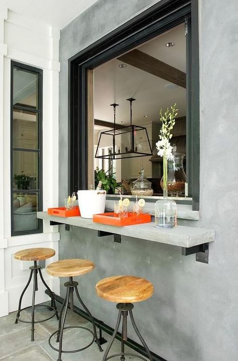 an industrial space with a concrete windowsill, metal and wood stools Pass Through Kitchen, Kitchen Window Bar, Belgian Farmhouse, Kitchen Pass Through, Kitchen Pass, Kitchen Bar Design, Window Bars, Outdoor Kitchen Bars, Luxe Interiors