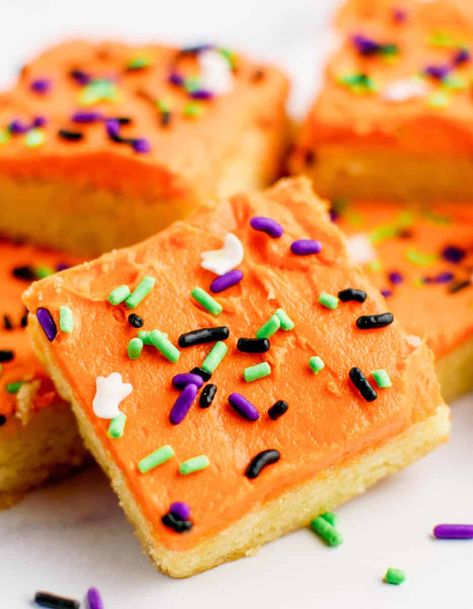 Soft, chewy sugar cookie bars with Halloween-themed frosting and sprinkles. The perfect treat for Halloween parties. Find the recipe here!