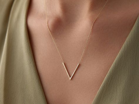 🌟 14K Gold V Necklace 🌟 Make a sleek statement with our 14K Gold V Necklace. This modern and minimalist piece features a simple V-shaped pendant, symbolizing victory, strength, and direction. Perfect for those who appreciate clean lines and contemporary design, this necklace adds a touch of elegance and edge to any outfit. Whether worn alone for a bold look or layered with other necklaces, it's a versatile accessory that effortlessly elevates your style. ✨ Available in three gorgeous colors--c V Chain Gold, Formal Gold Y-shaped Necklace, Gold Necklace V Shape, Initial Necklace V, V Letter Gold Pendant, Dramatic Style, Gold Necklace Women, 14k Gold Necklace, Gold Necklace Layered