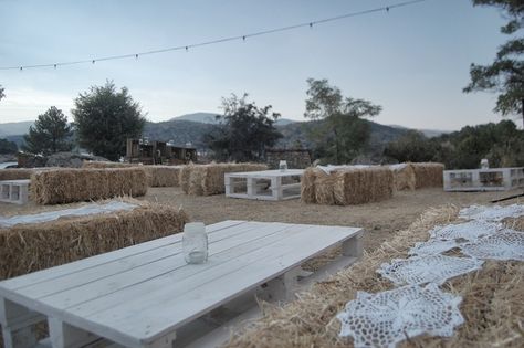 NATURAL PRE WEDDING DECOR  Lakeside reception .  String bulb lights, straw bale seats decorated with diy lace runners, palet tables & old wooden crates . Hay Seating, Hay Bale Wedding, Hay Bale Seating, Pallet Wedding, Deco Champetre, Hay Bales, Rustic Chic Wedding, Wedding Seating, Outdoor Party