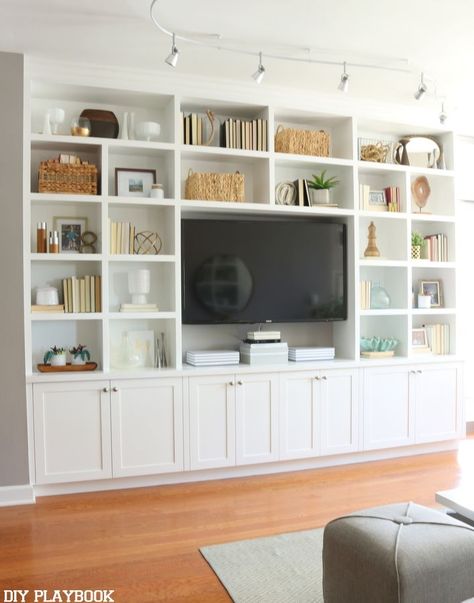 This white built-in entertainment center makes this room feel grand and inviting. Plus we love all of the storage and shelving to show off accessories. Tv Shelving, Chicago Condo, Ruang Tv, Built In Entertainment Center, Living Room Built Ins, Living Room Entertainment Center, Living Room Entertainment, Living Room Shelves, Room Shelves