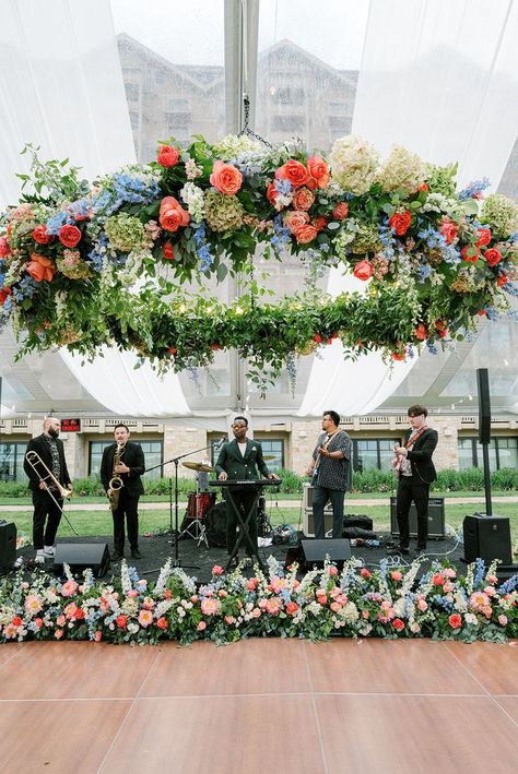 Coral rose, green hydrangea, blue delphinium, peach blush stock, white snapdragons wedding floral chandelier installation Snapdragons Wedding, Snapdragon Wedding, Band Setup, Chandelier Installation, Colorful Summer Wedding, Hydrangea Blue, Blue Delphinium, Creative Wedding Gifts, Floral Installations