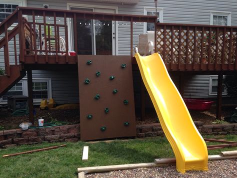 Backyard deck project for the kids. Rock wall and slide. Deck Rock Climbing Wall, Deck Slide Ideas, Deck Slides For Kids, Slide Off Of Deck, Slide From Deck, Slide Off Deck, Deck With Slide, Kids Climbing Wall, Backyard Furniture Diy