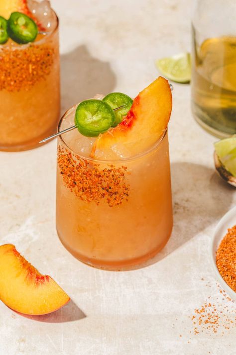 This ultimate spicy peach margarita mocktail recipe is made with jalapeño infused simple syrup, peach puree, and non-alcoholic tequila, and sparkling water. The perfect summer drink! Margarita Mocktail Recipe, Infused Simple Syrup, Margarita Mocktail, Virgin Margarita, Pink Drink Recipes, Peach Water, Peach Margarita, Peach Drinks, Frozen Grapes