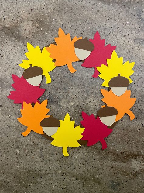 "This adorable fall wreath will make a great fall decoration for your home. Let your child arrange the wreath in whichever way they like best! :) I will send you all the pieces you need cut out of colored cardstock...all you need is glue! :)  You may want to add some tape to the back of the wreath for extra support! :) Fall wreath measures about 7.5\" across What's included: *2 brown half circles *3 red leaves *3 orange leaves *3 yellow leaves *5 dark brown acorn tops *5 light brown acorn bottom Fall Wreath Craft, Cardstock Paper Crafts, Couronne Diy, Paper Craft For Kids, Fall Classroom Decorations, November Crafts, Fall Leaf Wreaths, Construction Paper Crafts, Kids Fall Crafts