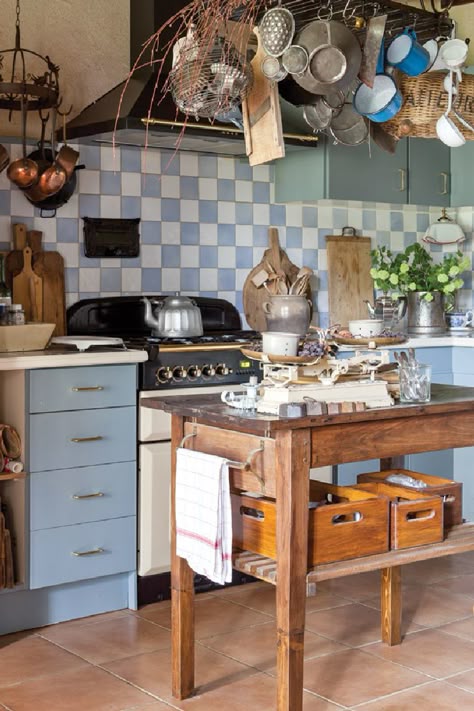 The kitchen features blue and white tiles found in a French market and a wooden table once used for drying cheeses. “Our interior decoration is not something we managed in a short period,” says Clementine, “but is the result of a lifetime of collecting nice brocante furniture and vintage items.” Come see 36 Best Beautiful Blue and White Kitchens to Love! #blueandwhite #bluekitchen #kitchendesign #kitchendecor #decorinspiration #beautifulkitchen Blue And White Kitchen Decor, Vintage Kitchen Decor Ideas, Grey Blue Kitchen, Best Kitchen Colors, Blue White Kitchens, Blue And White Kitchen, Cottagecore Kitchen, Blue Kitchen Decor, Blue Kitchen Cabinets