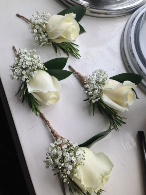 for a more rustic feel, you could have your buttonholes bound in twine. Buttonholes Wedding White, White And Green Buttonholes Grooms, Neutral Buttonholes, White Rose Buttoniere, Ivory Buttonhole, Wedding Flower Arrangements Table, White Rose Boutonniere, Unique Bridal Bouquets, Corsage And Boutonniere Set