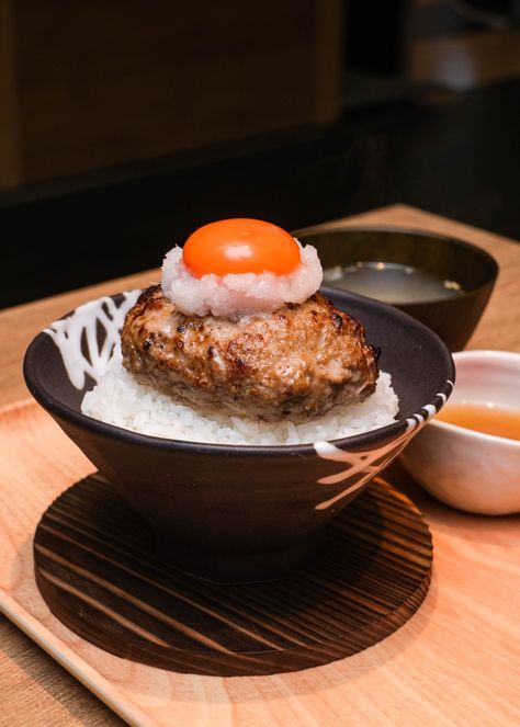 Tsukimi Hamburg Don - expect steaming rice, drizzled with bonito and kombu stock and topped with a thick Hamburg steak. Hamburg Steak Japanese, Japanese Diner, Japanese Hamburger Steak, Hamburg Steak, Japanese Food Photography, Japanese Wagyu, Sushi Go, Japanese Bakery, Japanese Steak