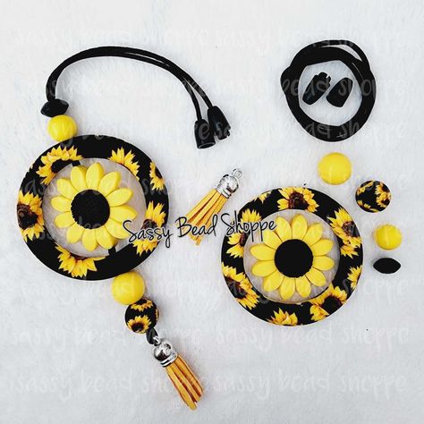 Delightful Flower Car Charm Kit DIY CAR CHARM KIT INCLUDES:   Kit will make 1 DIY CAR CHARM KIT CONTENTS: Supplies to make 1 Car Charm, including ~ ~ 1 - Black Sunflower Jumbo Silicone Ring (Complete car charm in the photo are for reference only. They are NOT included in the kit) ~ 1 - Sunflower Silicone Bead   ~ 4 - Silicone Color Coordinating Beads 12mm - 15mm ~ 1 -  Dark Yellow Tassel w/Silver Cap ~ 1 - 20" Black 2mm Satin Cord ~ 1 - Black Breakaway Clasp COMPLETE CAR CHARM IN THE PHOTO ARE FOR REFERENCE ONLY THEY ARE NOT INCLUDED IN THE KIT! YOUR CAR CHARM WILL NOT COME ASSEMBLED! YOU WILL GET EVERYTHING YOU NEED TO MAKE THE CAR CHARM SHOWN!! We post all our tutorials on our blog  https://sassybeadshoppe.com/blogs/sassy-bead-shoppe-blog Click the link to find the tutorial you're lookin How To Make Rearview Mirror Charms, Silicone Bead Ideas Diy, Keychain Crafts, Nurse Crafts, Beaded Car Charms, Pen Ideas, Black Sunflower, Yarn Creations, Bar Keychain