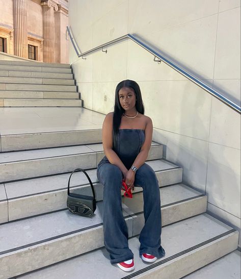 Black girl wearing black two piece set. Wearing red and white sneakers and red sunglasses. On the stairs is a black diesel bag. Black Diesel Bag Outfit, White Diesel Bag Outfit, Diesel Bag Outfit, Girl Streetwear Aesthetic, Girl Streetwear, Diesel Bag, Bag Outfit, Streetwear Fits, Streetwear Aesthetic