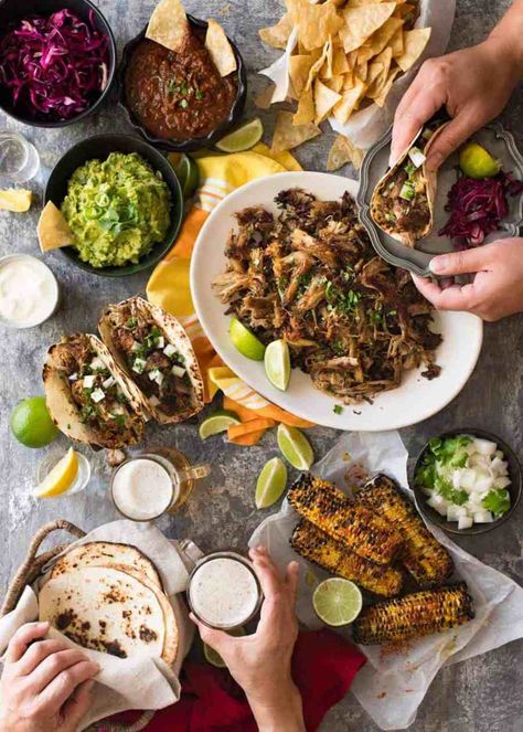 Overhead photo of Mexican Fiesta taco dinner party, with pork carnitas, tacos, grilled corn, guacamole, salsa, pickled red cabbage, tortilla chips and taco sides. Cabbage Tortilla, Taco Sides, Taco Dinner Party, Mexican Dinner Party, Pickled Red Cabbage, Carnitas Tacos, Guacamole Salsa, Taco Dinner, Carnitas Recipe