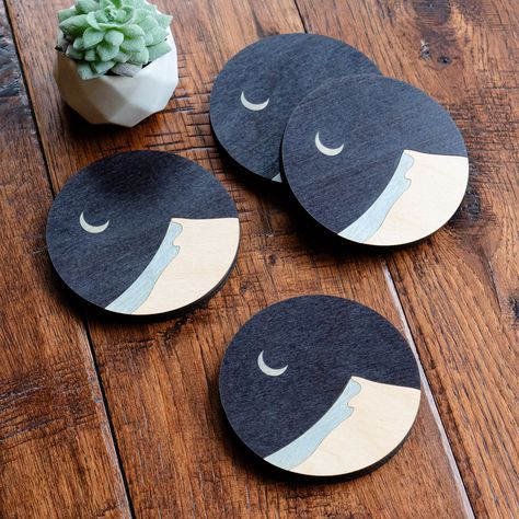 "Do you need a gift idea for your desert or nightscape lover in your life? This coaster design features a minimalist sand dune, a deep dark night sky, and crescent moon. These coasters are 3.8 inches in diameter and a luxurious 3/8\" inches thick. These pieces are made with layered wood and cork. The wood is stained, lacquered, and cut into different shapes to create the scene. The coasters have a cork bottom. This color scheme is also available without the Sand Dune! https://www.etsy.com/listin Ceramic Coaster Design, Minimalist Coasters, Night Sky Moon, Coaster Art, Wood Painting Art, Cycling Gifts, Cd Art, Desert Vibes, Sports Wall Art