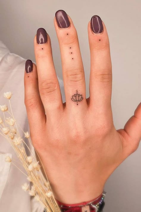 36 Beautiful Lotus Tattoos (Design & Meaning - 2021 Guide) Mini Tats Cross, Dot Tattoos On Fingers Meaning, Small Tattoos Mandala, Lotus Tatoos Meaning, Finger Dots Tattoo, Dot Finger Tattoo Meaning, Womens Finger Tattoos Simple, Finger Dot Tattoo Meaning, Dot Tattoos On Fingers