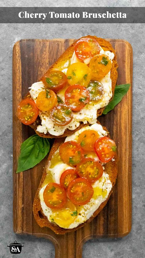 Two slices of Cherry Tomato Bruschetta on a wooden serving board. Fresh Tomato Bruschetta, Double Tomato Bruschetta, Cherry Tomato Bruschetta Recipe, Tomato On Bread Appetizer, Tomatoes With Burrata, Mozarella Appetizer Cherry Tomatoes, Cherry Tomato Bruschetta, Cherry Tomato Appetizers, Brushetta Appetizers Cherry Tomatoes