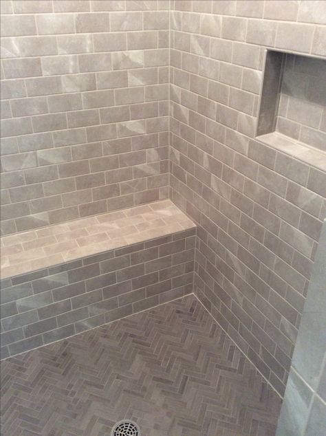 Walk-in shower with bench seat, herringbone floor, grey toned tile and 3x6 subway wall tile. Tiled Shower Bench Seat, Walk In Shower With Bench Seat, Subway Tile Shower Bench, Subway Tile Shower Bench Seat, Tiled Floating Shower Bench, Walk In Shower With Seat, Homestead Bathroom, Shower With Bench Seat, 3x5 Walk In Shower With Bench