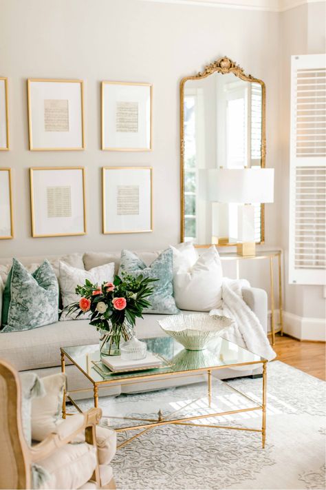 Living Room With Gold Coffee Table, White Marble Coffee Table Decor, French Mirror Living Room, Lamp On Books, Antique White Living Room Walls, Gold Mirror Living Room Decor, Gold Coffee Table Decor, Gold Mirror Living Room, Glam Console Table