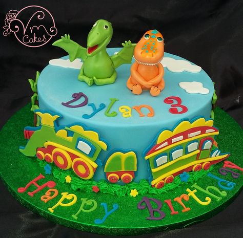 'Dinosaur Train' theme celebration cake Dinosaur Train Cake, Dinosaur Truck Cake, Dinosaur Train Birthday Cake, Dino Monster Truck Cake, Blue And Green Dinosaur Cake, Train Birthday Party Cake, Dinosaur Train Cakes, Dinosaur Train Party, Wilton Dinosaur Cake