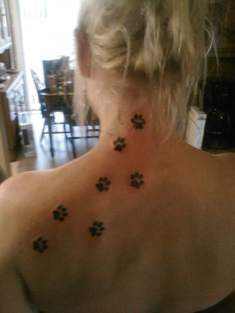 Considering one paw print in the center of the back of my neck too .. Paw Print Spine Tattoo, Paw Print Trail Tattoo, Tattoo On Back Of Neck, Tatted Women, Wolf Paw Tattoos, Paw Tattoos, Tattoos On Back, Symbol For Family Tattoo, Lower Back Tattoo Designs