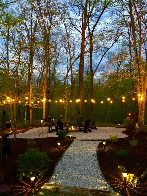 Backyard Patio Designs With Trees, Lights Around Fire Pit Backyard, Outdoor Fire Pit Lights, Garden Around Fire Pit Area, Large Backyard No Grass Ideas, Outdoor Fire Pit With String Lights, Landscape With Fire Pit, Walkway To Fire Pit Area, String Lights Over Fire Pit