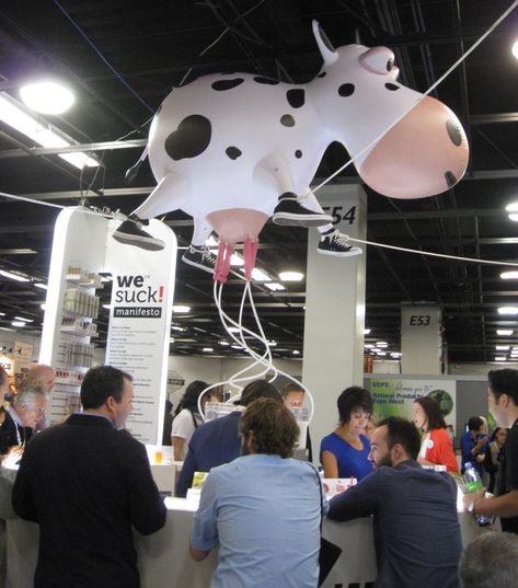 Large inflatable hangs over booth area surrounded by rounded sampling table for a milk brand. Spotted at the Natural Products Expo show. #ExpoWest Milk Display, Product Sampling, Brand Activation Ideas, Activation Ideas, Expo West, Cow Parade, Milk Brands, Digital Media Design, Brand Activations