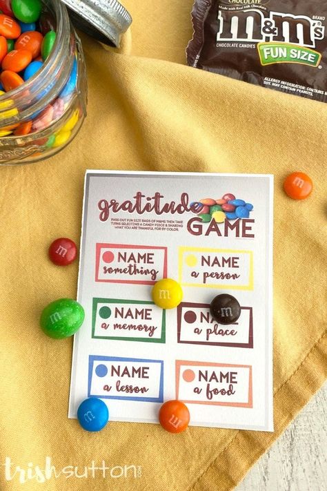 Give thanks for Thanksgiving and make those moments of grateful splendor a little sweeter with this free printable Gratitude Game. It's the perfect way to keep the kids occupied while waiting for dinner on Thanksgiving Day. #kenarry Skittles Gratitude Game, Grateful Party Ideas, Gratitude Activity Days Lds, M&m Gratitude Game, Gratitude Game Free Printable, Gratitude Bracelet Diy, M&m Thankful Game, Thanksgiving Ministering Ideas, November Activity Days Ideas Lds