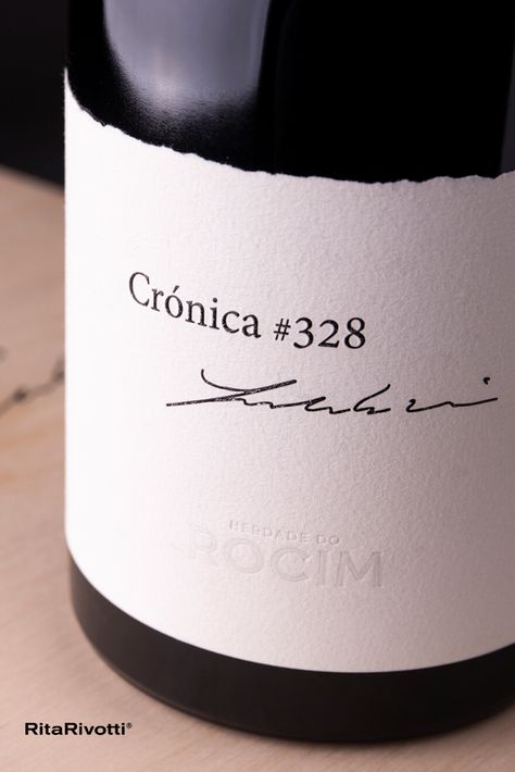 This project’s premium wine pays tribute to its founder, José Ribeiro Vieira. A man who wrote his thoughts in chronicles he published. Inspired by this legacy, we called it Crónica#328, after the text he left unfinished, but which his daughter and son-in-law were able to continue. The bottle lies on a sheet of paper, as if they were part of each other, in a wooden box, elegant and complex, like the wine and the man it honours. #ritarivotti #branding #winedesign #winepackaging #winelabel Minimal Wine Label Design, Minimal Label Design, Wine Styling, Italian Wine Label, Red Wine Label, Modern Wine Labels, Red Wine Labels, Wine Bottle Label Template, Wine Branding