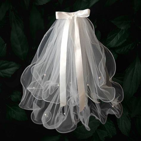 "madewhite.etsy.com ❤ Our stunning Korean-style hair bow wedding veil, designed to add an extra touch of cuteness and elegance to your bridal look. Made with delicate tulle material, this shoulder-length veil features a beautiful hair bow at the top that adds a touch of sweetness to your appearance.  ❤ This veil is perfect for brides who are looking for a cute and romantic touch to their bridal look. The shoulder-length design is ideal for brides who want to show off their wedding gown while still having the traditional bridal veil. The veil is lightweight and easy to wear, ensuring that you remain comfortable throughout the ceremony and reception. ❤ Our Korean-style hair bow wedding veil is perfect for both indoor and outdoor weddings and is versatile enough to complement a range of weddi Hair Bow Veil, Bow Wedding Veil, Shoulder Veil, Shoulder Length Veil, Bow Veil, Bridal Bow, Veil Hair, White Veil, Wedding Gown Styles