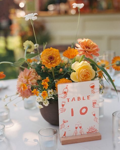 Warm neutrals, pops of orange and deep green, and hand drawn illustrations by the groom really pull together this 70s inspired, funky, garden party dinner in an apple orchard. @dawnranch is the perfect pairing of summer camp vibes and elegant garden party and their apple orchard is the perfect place for dinner. We love when clients want to make sure that their wedding doesn’t look like everyone else’s and think outside of the box on colors. While we may be seeing orange everywhere next year... Tablescape With Oranges, Green Wedding With Pop Of Color, Fall Colorful Wedding, Sage Green And Orange Wedding, Orange And Green Wedding Colors, Primary Color Wedding, Bright Fall Wedding Colors, Garden Party Dinner, Chartreuse Wedding