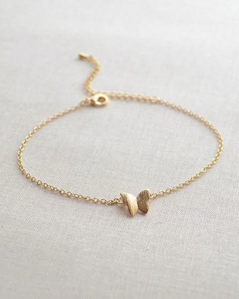 This butterfly bracelet is so dainty and feminine. It is adjustable from 7 - 9 inches, so it will fit any size wrist. The small butterfly charm measures approximately 1/2 inch. Currently only availabl Grunge Necklace, Butterfly Bracelet, Fancy Jewellery, Gold Earrings Designs, Fancy Jewelry, Hand Jewelry, Girly Jewelry, Stylish Jewelry, Gold Jewelry Fashion