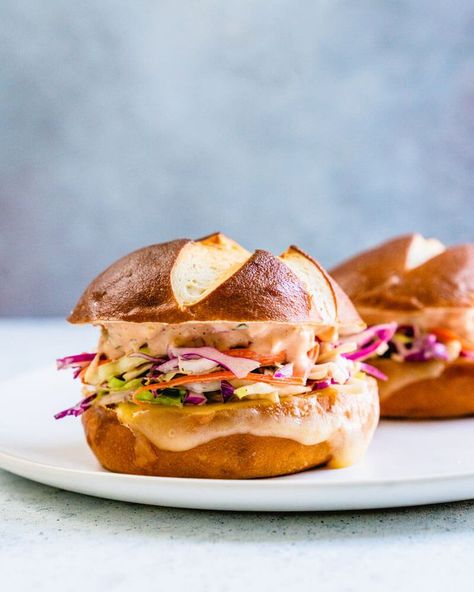 This coleslaw & Swiss cheese melt sandwich might be the best sandwich ever. Slathered with creamy Russian dressing, it's over the top delicious. #sandwich #vegetarian #coleslaw #swisscheese #melt #lunch #mealprep #dinner Melted Cheese Sandwich, Best Coleslaw, Coleslaw Sandwich, Best Coleslaw Recipe, Vegetarian Sandwich Recipes, Vegan Coleslaw, Pretzel Bun, Russian Dressing, Creamy Coleslaw