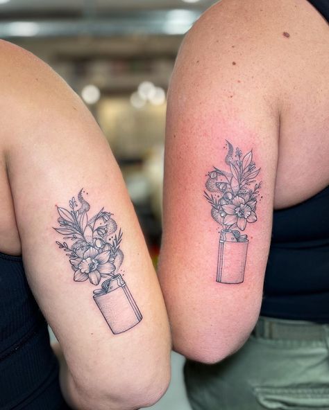 Check out these adorable matching tattoos of blooming flowers cleverly sprouting from lighters! Did you notice the lighters immediately? A perfect symbol of friendship, lighting up each other's lives. Such a sweet and meaningful way to celebrate best friends forever! @kaur_daljeett, you really nailed it with this one! 🌼💕 ⁠ Matching Tattoos For Best Friends American Traditional, Matching Lighter Tattoos, Lighter With Flowers Tattoo, Nature Matching Tattoos, Matching Floral Tattoos, Lighter Tattoo, Illustrative Tattoos, Mama Tried, Light Tattoo