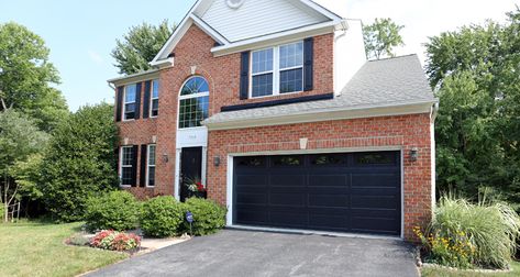 This home features an insulated black garage door from the Thermacore® Collection. Installed by Overhead Door Company of Washington, DC™. Black Garage Doors On Red Brick House, Black Garage Doors On Brick House, Garage Door Black Paint, Brick House With Black Garage Door, Red Brick House Black Garage Door, Red Brick House With Black Garage Doors, Black Garage Doors Brick House, Red Brick Black Garage Door, Brick House Black Garage Door