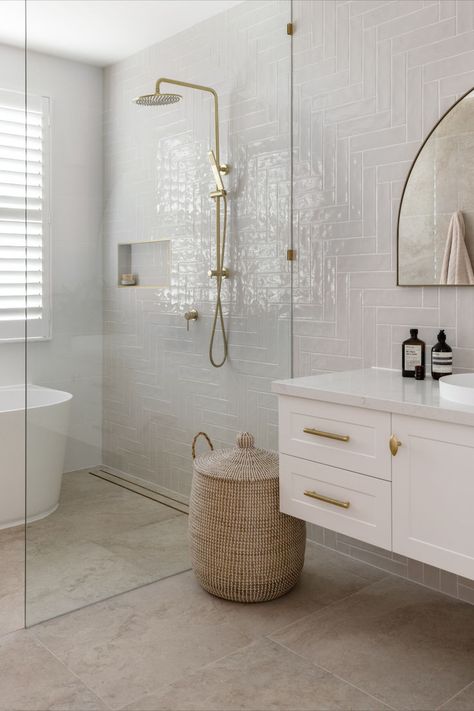 This hamptons style bathroom features a single shaker vanity, with an arch mirror and brushed brass tapware. Bathroom With Gold Fixtures, Modern Hamptons Bathroom, Hamptons Bathroom Ideas, Hamptons Bathrooms, Hampton Style Bathroom, Hampton Style Bathrooms, Hamptons Style Bathroom, Coastal Hamptons Style, Hamptons Interior Design