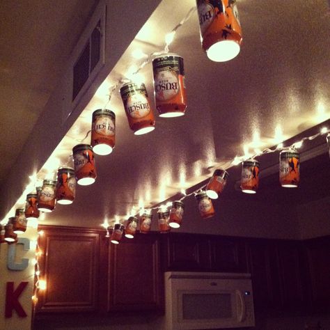 I've got a whole bunch of retro miller lite cans...this is happening! Repurposed Beer Cans, Beer Can Lights Diy, Beer Can Lights, Beer Can Decorations Diy, Beer Can String Lights, Beer Can Chandelier, Diy Beer Can Crafts, Beer Can Art Diy, Beer Can Decor