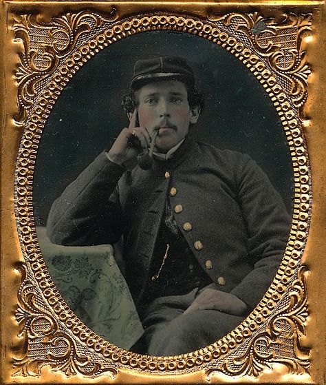 Sixth plate ambrotype of a Union soldier posing as if some deep thought. Resting with his elbow on the table at his side with a burl pipe clenched in his teeth, he wears a chasseur cap and a very plain jacket with no rank present. A great image with nice tinting on the table cloth and housed in a full leatherette case. 1800s America, 19th Century America, 1860s Underpinnings, Colonial Portraits Early American, Soldier Images, 1860s Portrait Painting, Union Soldiers, Vintage Photography, Art Reference Poses