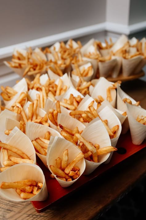 this french fry bar is set up with small paper cones of french fries, which are in boardwalk style french fry holders Party Snacks Wedding, Reception Treat Ideas, Midnight Snack At Wedding, Fries At Wedding, Cocktail Wedding Food Ideas, French Fry Wedding Bar, Wedding Fast Food Bar, Wedding Food Late Night, End Of The Night Wedding Snacks