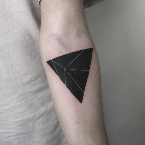 Tattoo of a black triangle divided into six different parts by white lines on the left forearm Black Triangle Tattoo, Triangle Tattoo Meaning, Unique Tattoos Black Women, Small Wave Tattoo, Glyph Tattoo, Triangle Tattoos, Back Of Shoulder Tattoo, Space Tattoo, Waves Tattoo