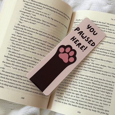 Happy #nationalbookloversday ! I’m so happy that I’m releasing my bookmarks on this day!!! Here’s one of my themes , I also have this available in doggy paws as well! These are completely handmade , hand drawn , and made with love! They’re laminated for extra protection as well 🩷 Share this with someone who loves cats!!! . . . #bookmarkshop #bookmarkart #catloverclub #bookishgirl #bookishart #bookloversofinstagram #bookstagram Cat Paw Bookmark, Easy Homemade Bookmarks, Book Mark Ideas Creative, Bookmarks Handmade Aesthetic, Bookmark Ideas Aesthetic, Book Marks Design Ideas, Bookmark Design Ideas, Bookmarks Aesthetic, Aesthetic Bookmarks