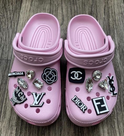 Pink Croc Aesthetic, Pink Crocs With Jibbitz, Croc Charm Ideas, Pink Croc Inspiration, Pink Bling Crocs, Light Pink Crocs With Charms, Croc Charms Pink, Pink Blinged Out Crocs, Designer Crocs